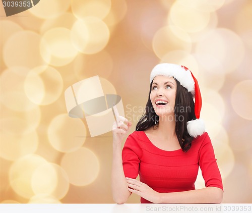 Image of smiling woman in santa helper hat