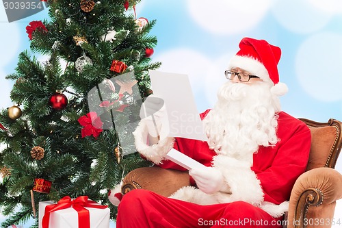 Image of man in costume of santa claus with letter