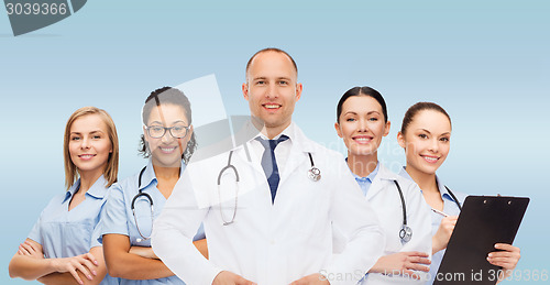 Image of group of smiling doctors with clipboard