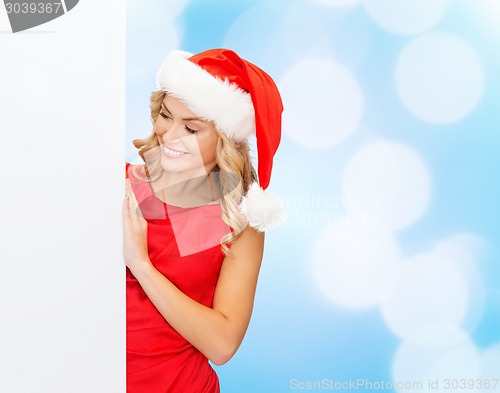 Image of smiling young woman in santa hat with white board