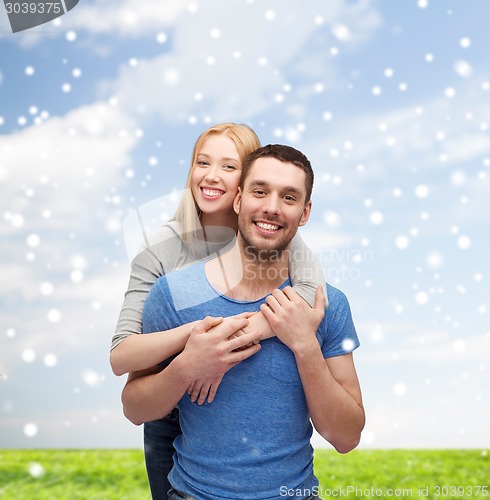 Image of happy couple hugging outdoors