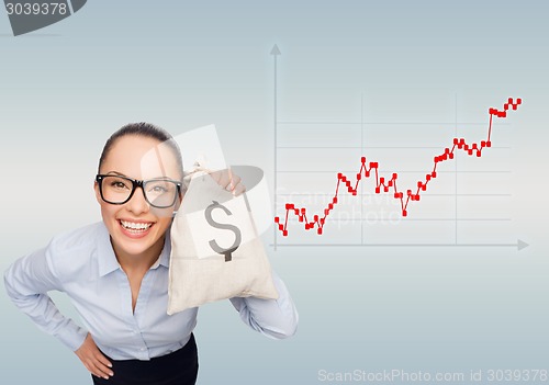 Image of happy businesswoman holding money bag with dollar