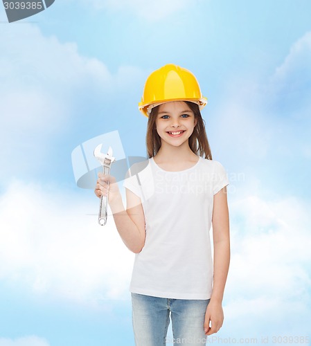 Image of smiling little girl in hardhat with wrench