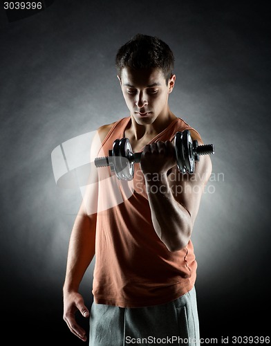 Image of young man with dumbbell