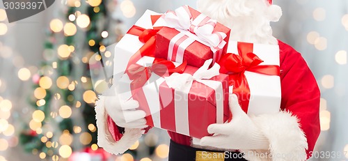 Image of man in costume of santa claus with gift box