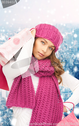 Image of smiling young woman with shopping bags