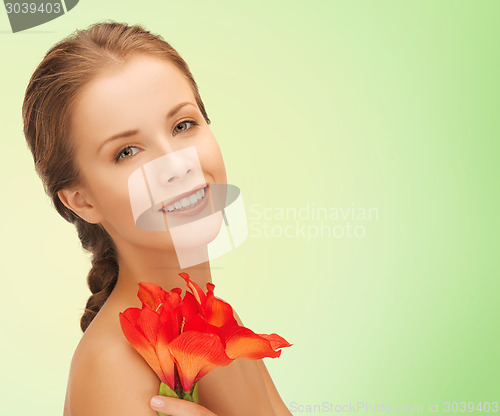 Image of beautiful smiling young woman with flowers