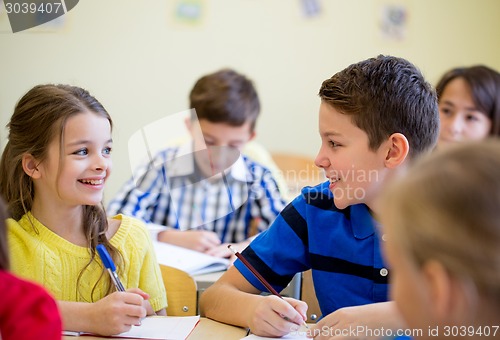 Image of group of school kids writing test in classroom