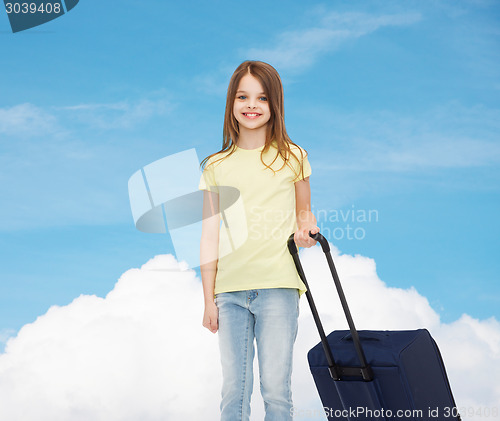 Image of smiling little girl with suitcase