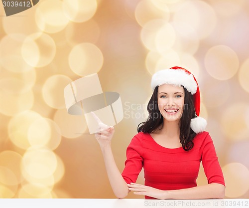 Image of smiling woman in santa helper hat