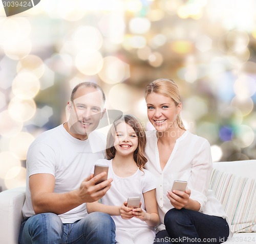 Image of happy family with smartphones