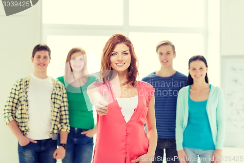 Image of smiling students with teenage girl in front