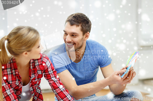 Image of smiling couple selecting color from samples