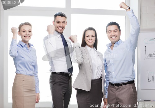 Image of business team celebrating victory in office