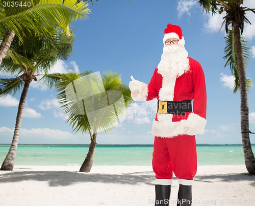 Image of man in costume of santa claus showing thumbs up