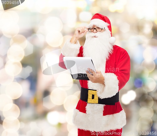 Image of man in costume of santa claus with notepad