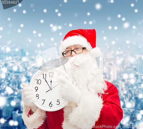 Image of man in costume of santa claus with clock