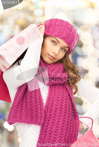 Image of smiling young woman with shopping bags