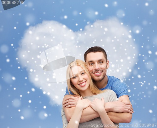 Image of happy couple hugging outdoors