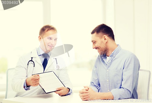 Image of doctor with clipboard and patient in hospital