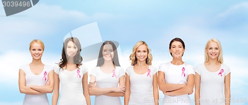 Image of smiling women with pink cancer awareness ribbons
