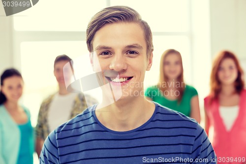 Image of smiling students with teenage boy in front
