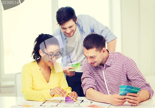 Image of smiling interior designers working in office