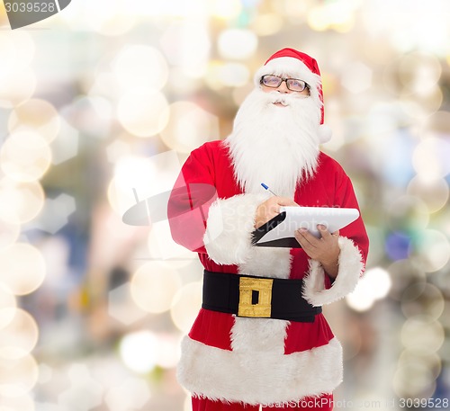 Image of man in costume of santa claus with notepad