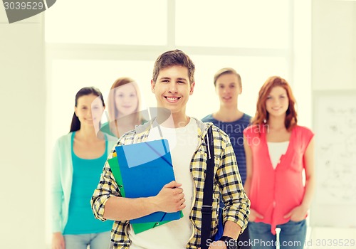 Image of smiling students with teenage boy in front