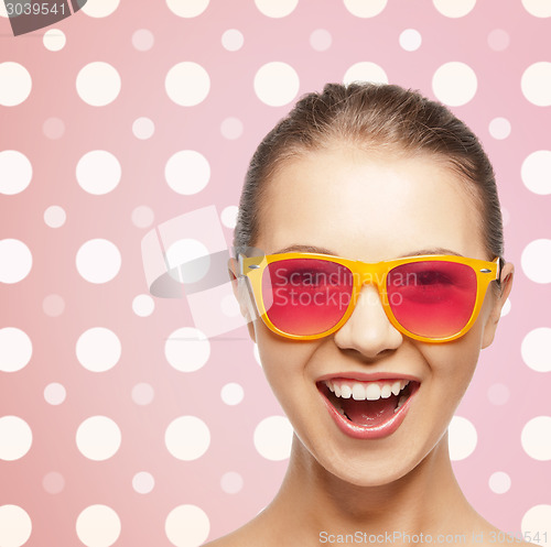 Image of happy laughing teenage girl in pink shades