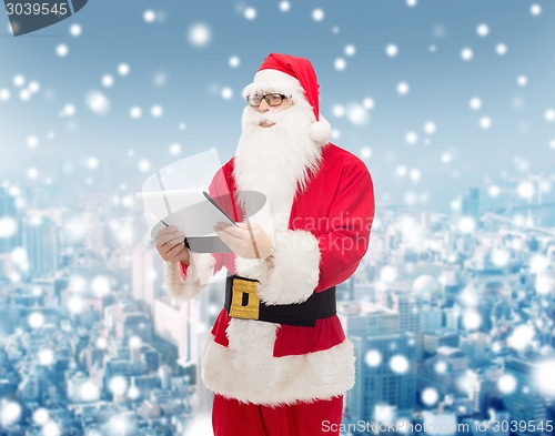 Image of man in costume of santa claus with notepad