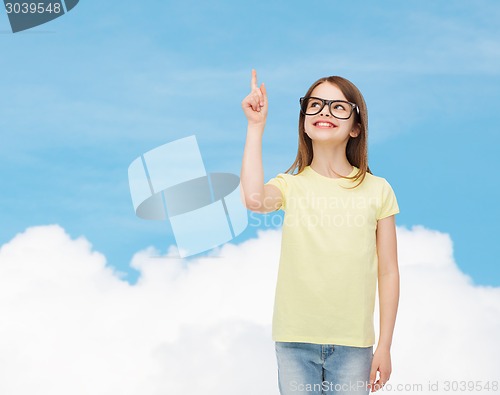 Image of smiling cute little girl in black eyeglasses