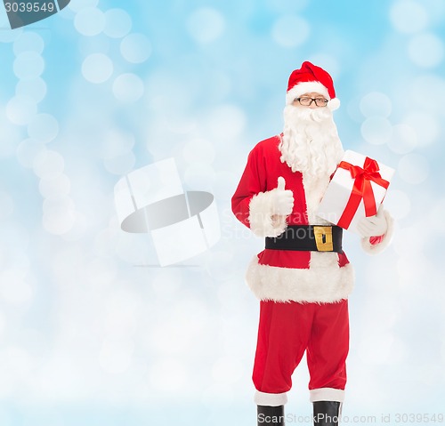 Image of man in costume of santa claus with gift box