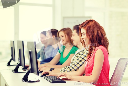 Image of female student with classmates in computer class