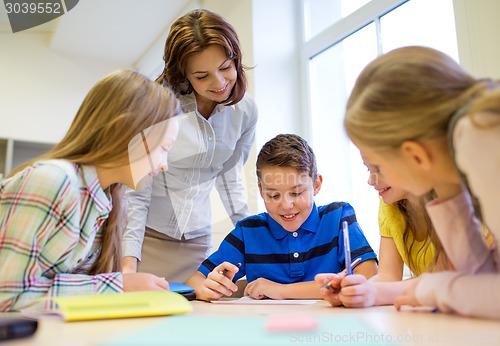 Image of group of school kids writing test in classroom