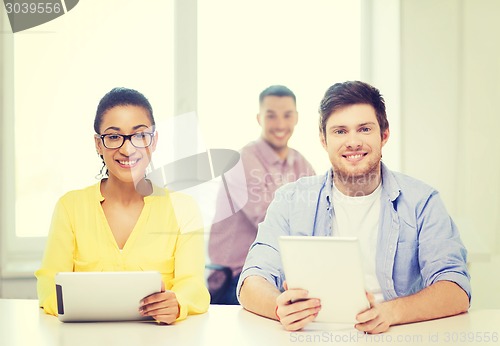 Image of smiling team with tablet pc computers at office