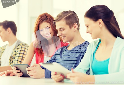 Image of smiling students with tablet pc at school