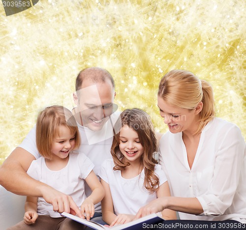 Image of happy family with book at home