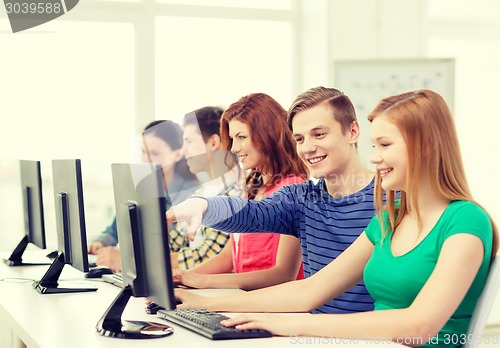 Image of female student with classmates in computer class