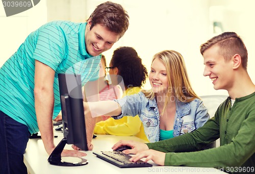 Image of smiling students in computer class at school