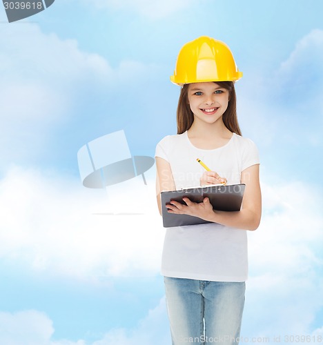 Image of smiling little girl in hardhat with clipboard