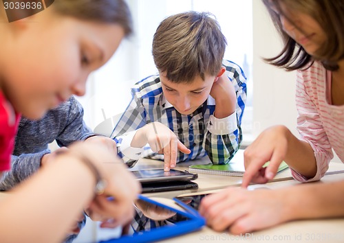 Image of group of school kids with tablet pc in classroom