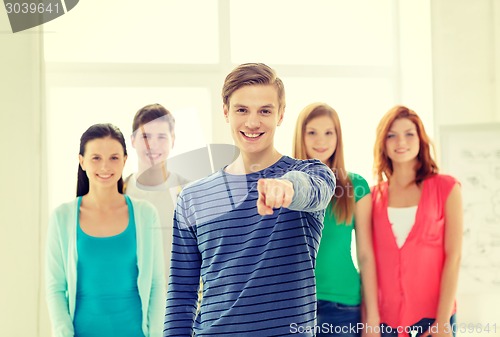 Image of students with teenager in front pointing at you