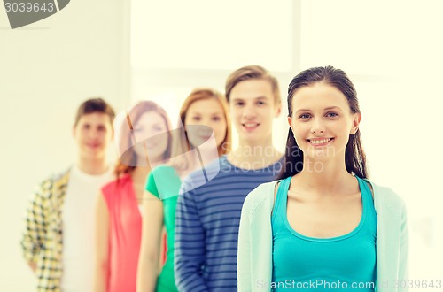 Image of smiling students with teenage girl in front