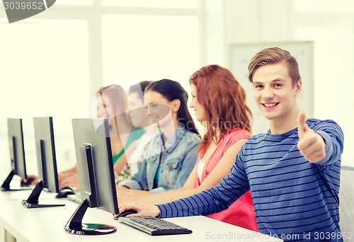 Image of male student with classmates in computer class