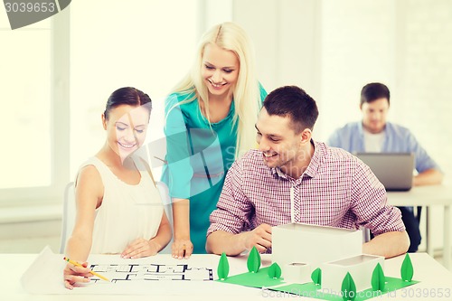Image of smiling architects working in office