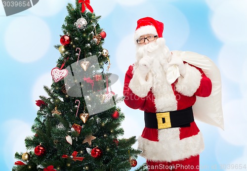 Image of santa claus with bag and christmas tree