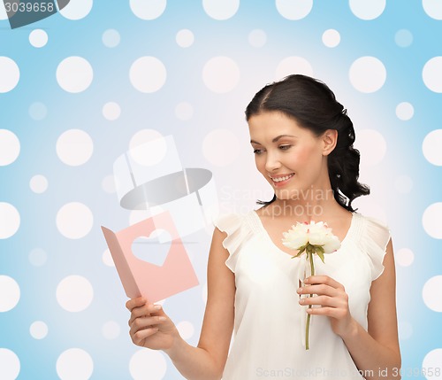 Image of smiling young woman with flower