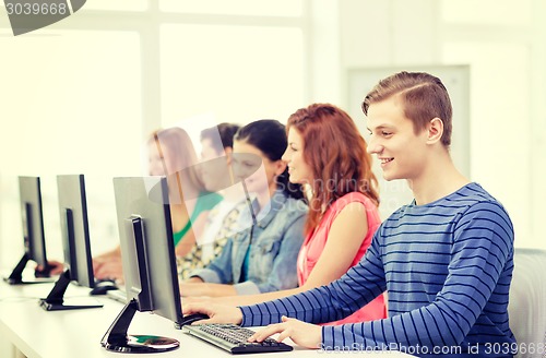 Image of male student with classmates in computer class