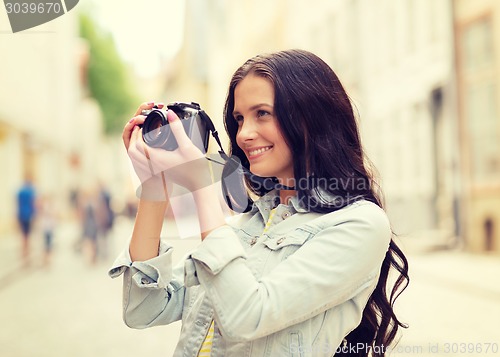 Image of smiling teenage girl with camera